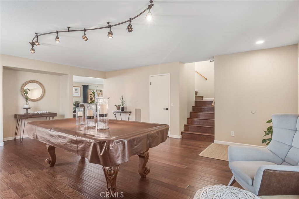 4330 Forest Ranch Way Oceanside, CA 92057 - Photo 7 of 51 Just off the entry, the formal living room sets a versatile tone, featuring a custom light fixture and a built-in niche ready to become your statement moment, perfect for a stylish bar setup or a tucked-away workspace.