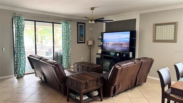 a kitchen with stainless steel appliances granite countertop a stove a refrigerator a sink dishwasher a dining table and chairs with wooden floor