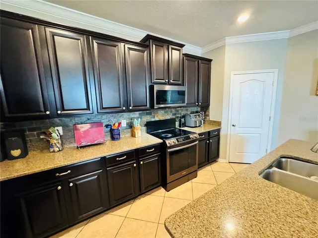 a bathroom with a granite countertop sink and a bathtub