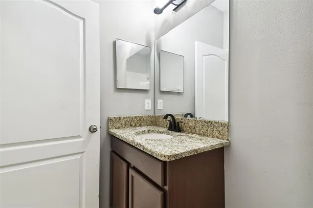 an aerial view of residential houses with outdoor space and lake view