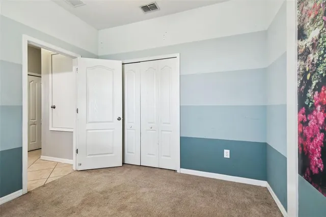 an aerial view of a house with a yard and lake view