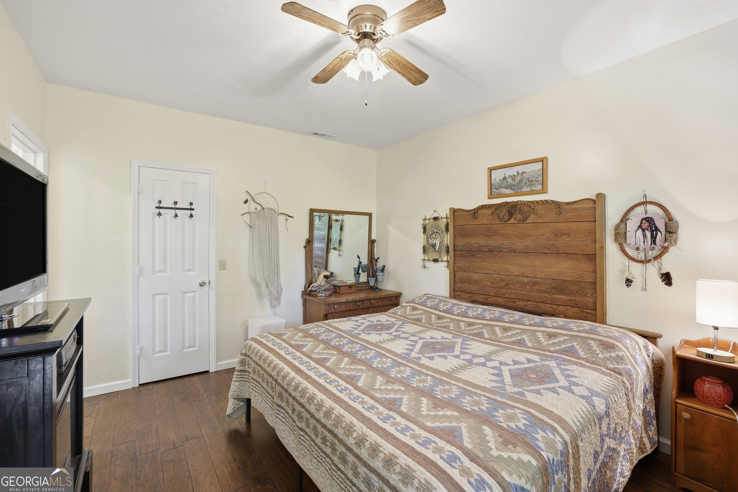 584 Battle Branch Vista Road Franklin, NC 28734 - Photo 16 of 46 a bedroom with a bed and a chandelier
