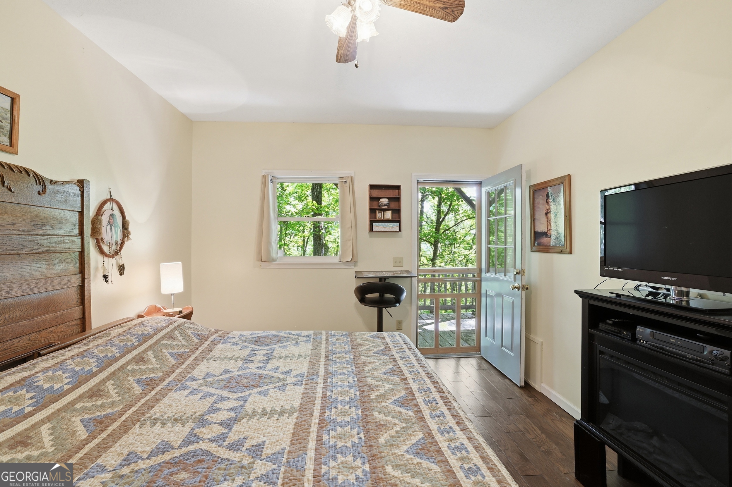 584 Battle Branch Vista Road Franklin, NC 28734 - Photo 17 of 46 a bedroom with a bed and a flat tv screen on dresser