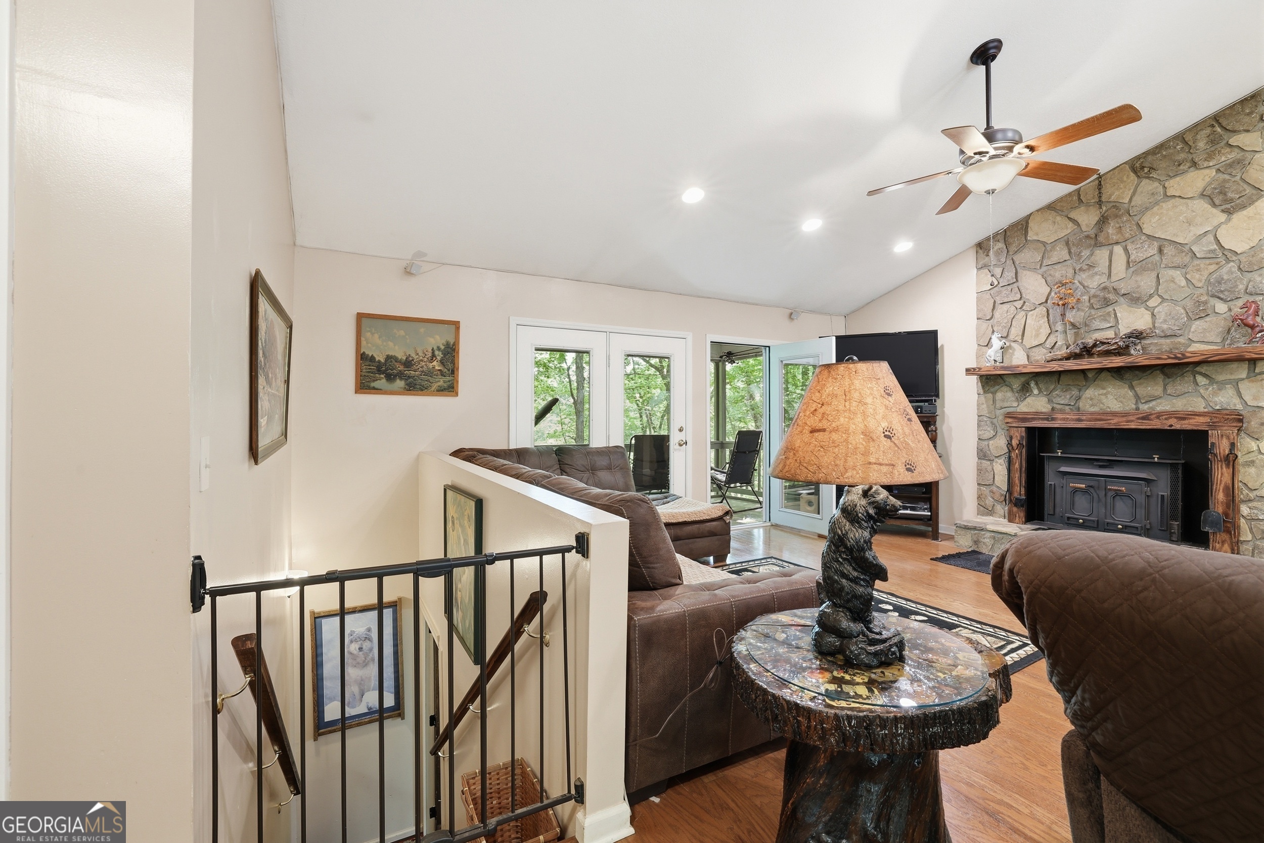584 Battle Branch Vista Road Franklin, NC 28734 - Photo 23 of 46 a living room with furniture a fireplace and a chandelier
