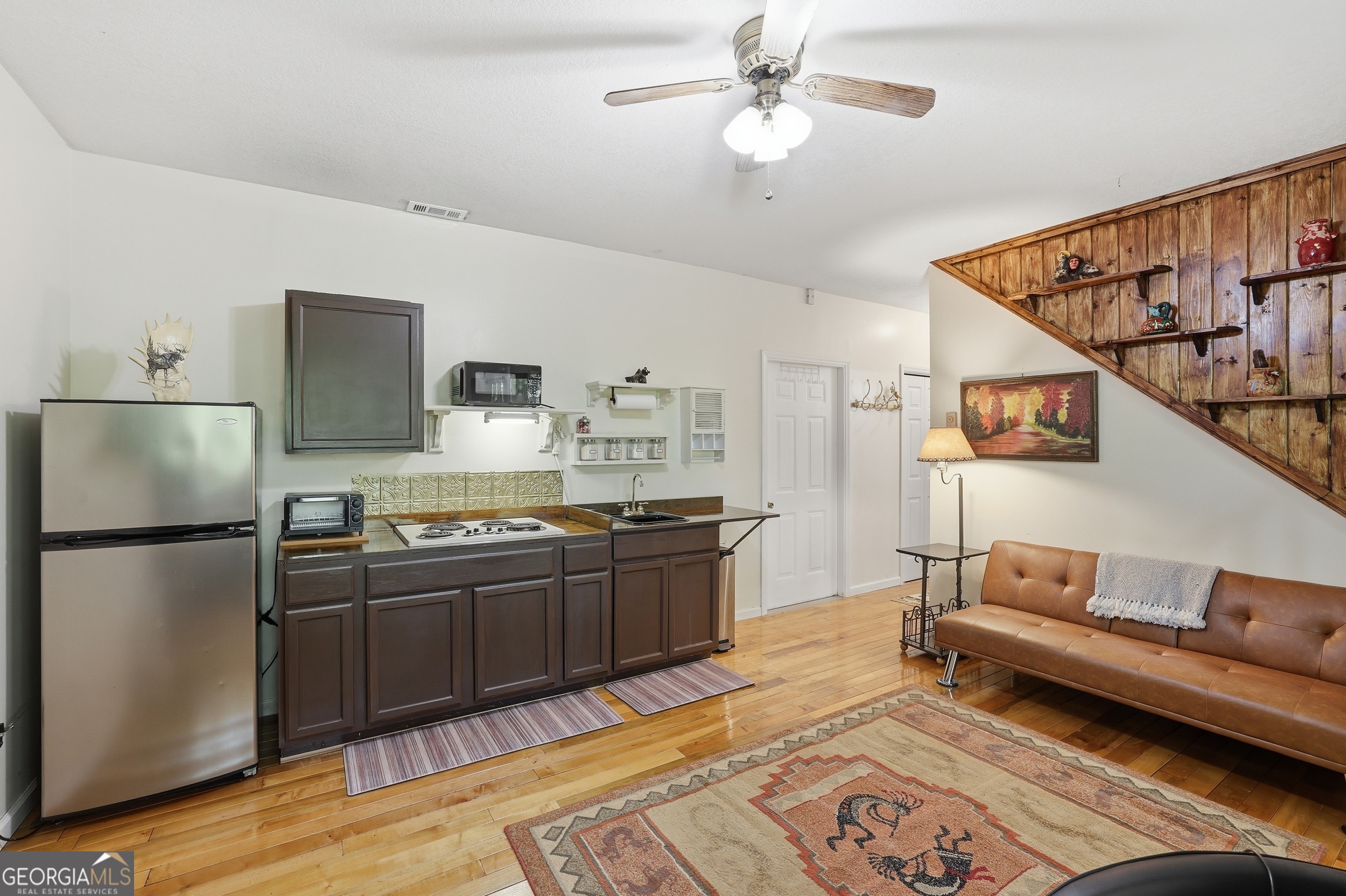 584 Battle Branch Vista Road Franklin, NC 28734 - Photo 26 of 46 a kitchen with stainless steel appliances granite countertop a refrigerator a stove and a sink with wooden floor