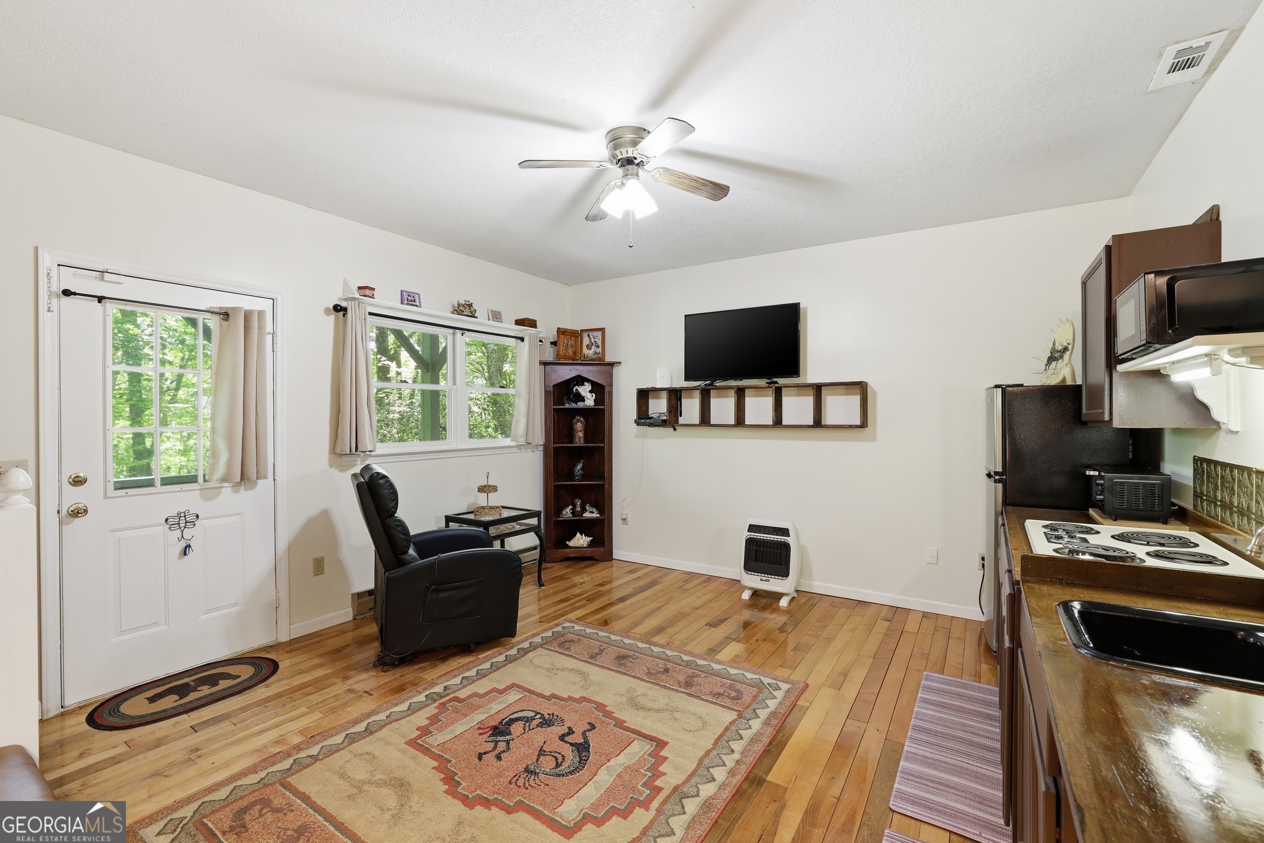 584 Battle Branch Vista Road Franklin, NC 28734 - Photo 28 of 46 a living room with furniture and a flat screen tv