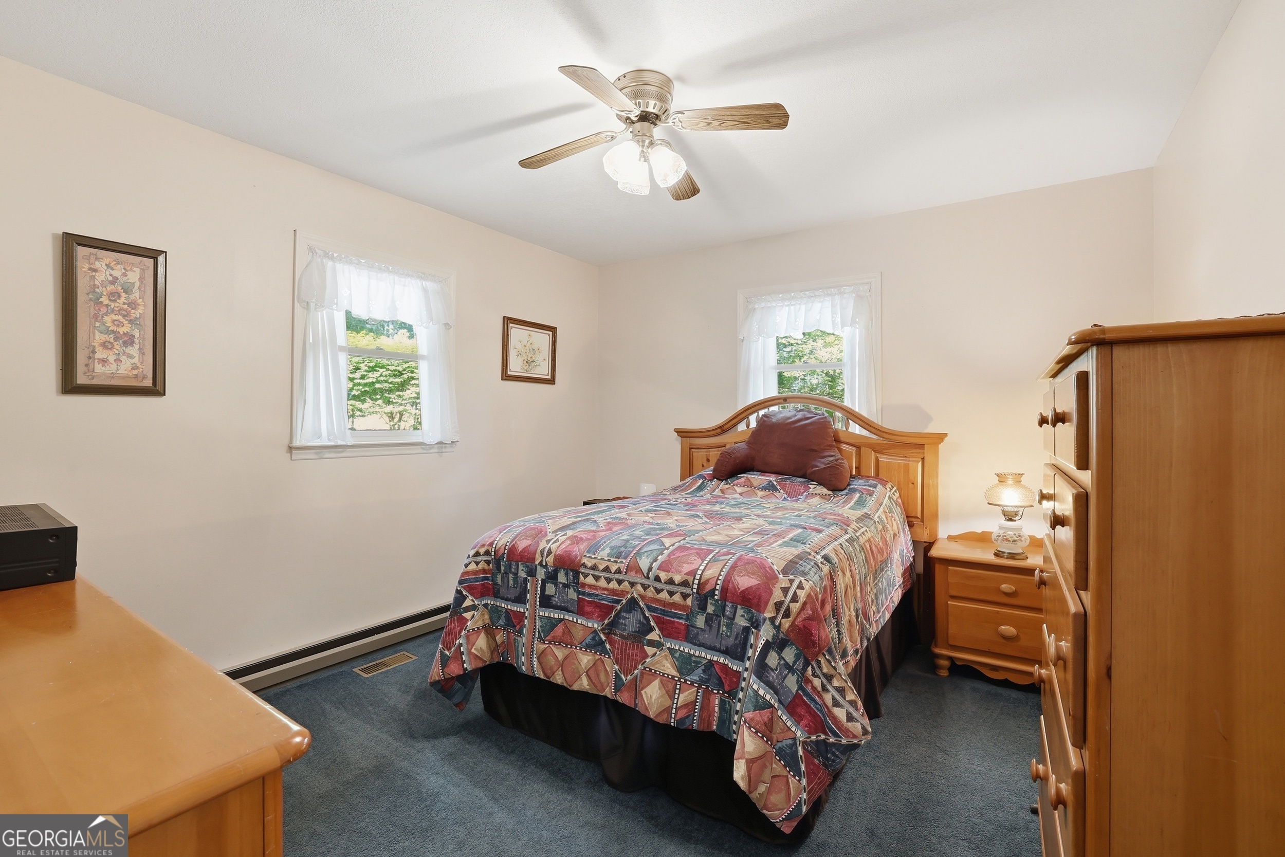 584 Battle Branch Vista Road Franklin, NC 28734 - Photo 30 of 46 a bedroom with a bed and a chandelier