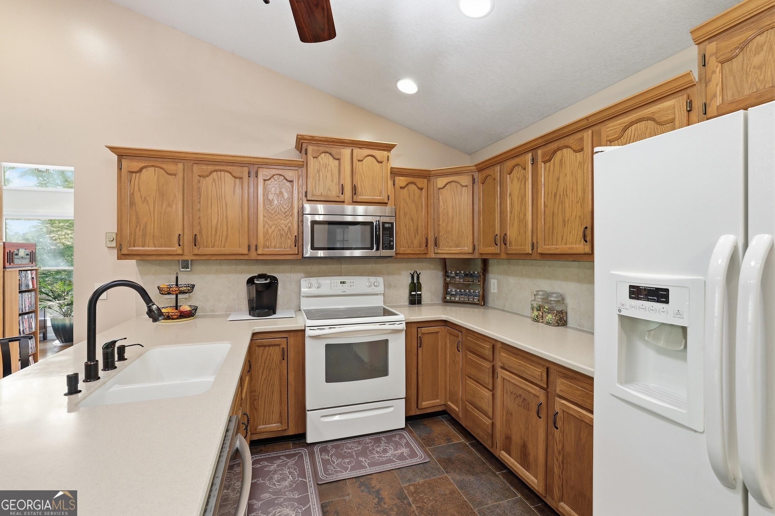 584 Battle Branch Vista Road Franklin, NC 28734 - Photo 9 of 46 a kitchen with kitchen island granite countertop a sink stainless steel appliances and white cabinets