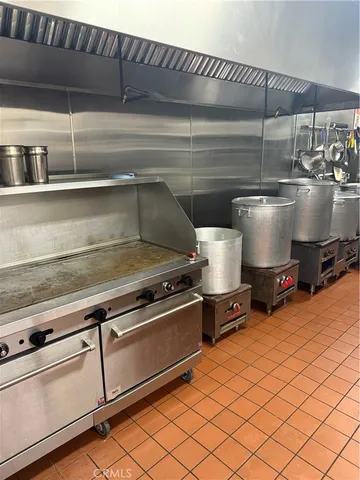 a stove top oven sitting inside of a kitchen