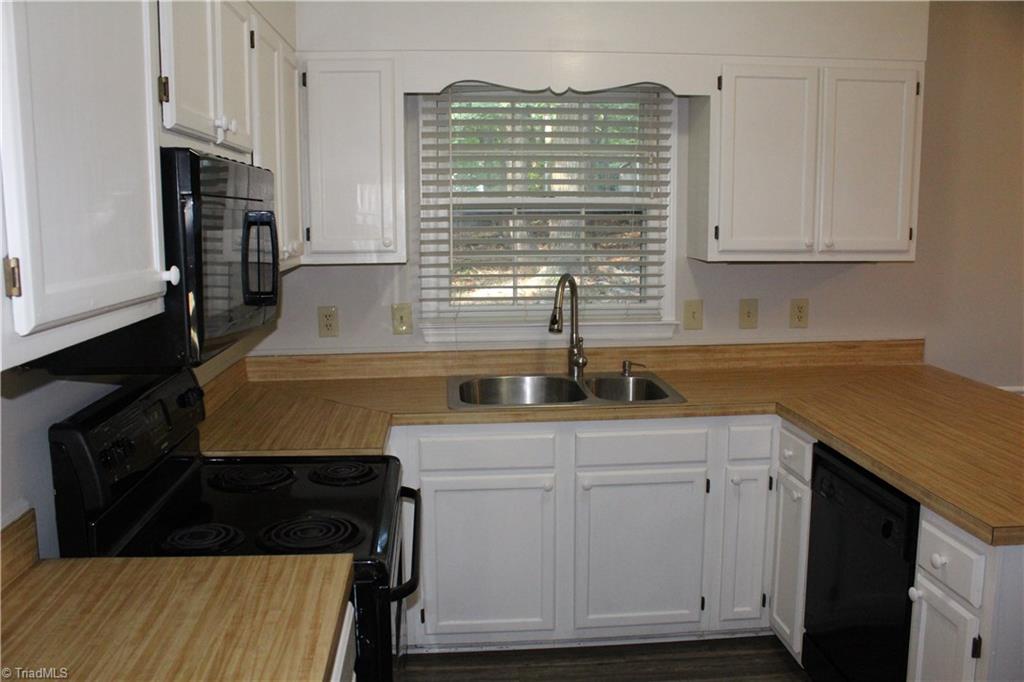 1122 Eagle Road Greensboro, NC 27407 - Photo 9 of 16 Kitchen with sink overlooking the backyard