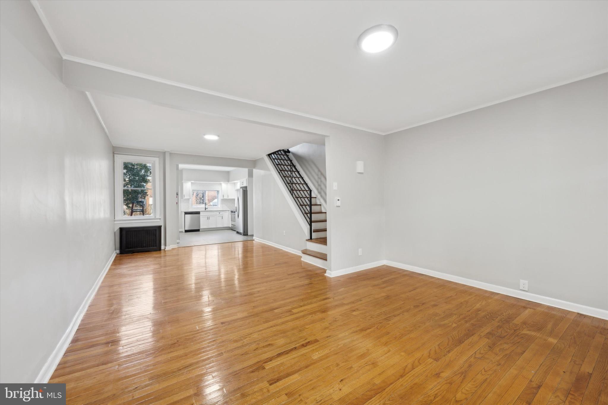 147 7th Avenue Roebling, NJ 08554 - Photo 4 of 13 a view of an empty room with wooden floor and stairs