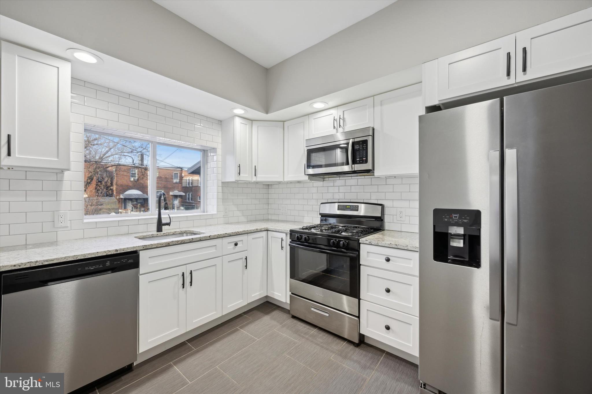 147 7th Avenue Roebling, NJ 08554 - Photo 7 of 13 a kitchen with white cabinets and stainless steel appliances