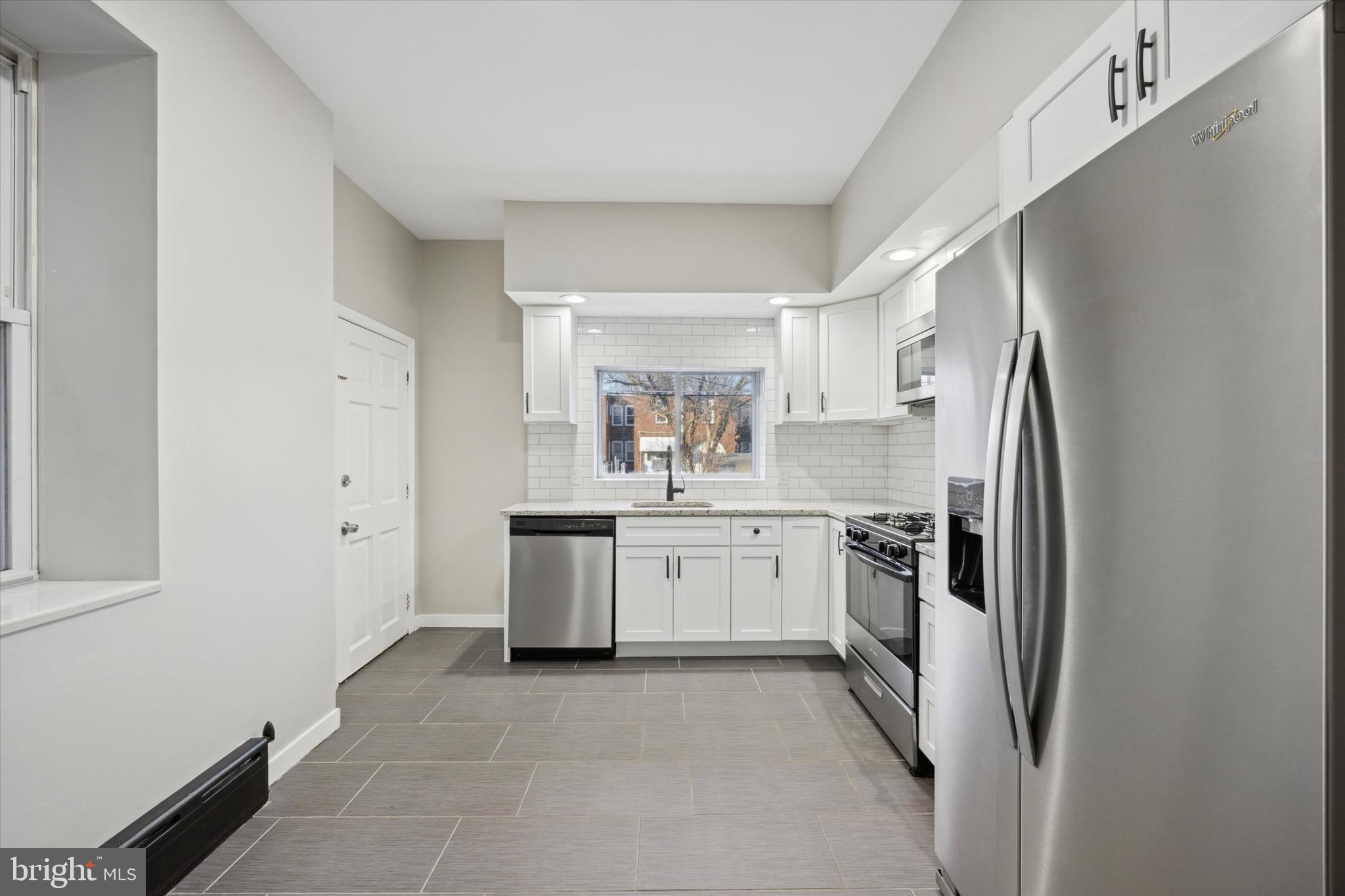 147 7th Avenue Roebling, NJ 08554 - Photo 8 of 13 a kitchen with white cabinets and refrigerator