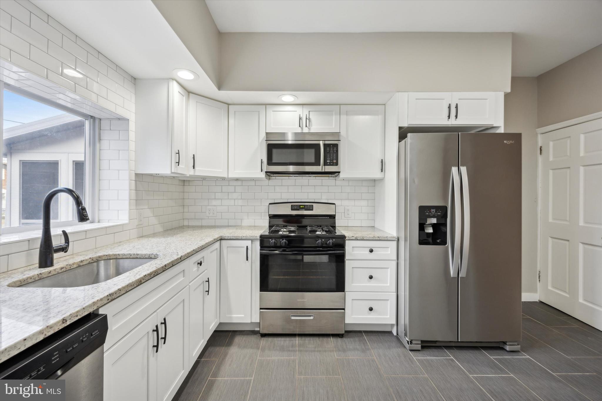 147 7th Avenue Roebling, NJ 08554 - Photo 9 of 13 a kitchen with stainless steel appliances a refrigerator sink and microwave