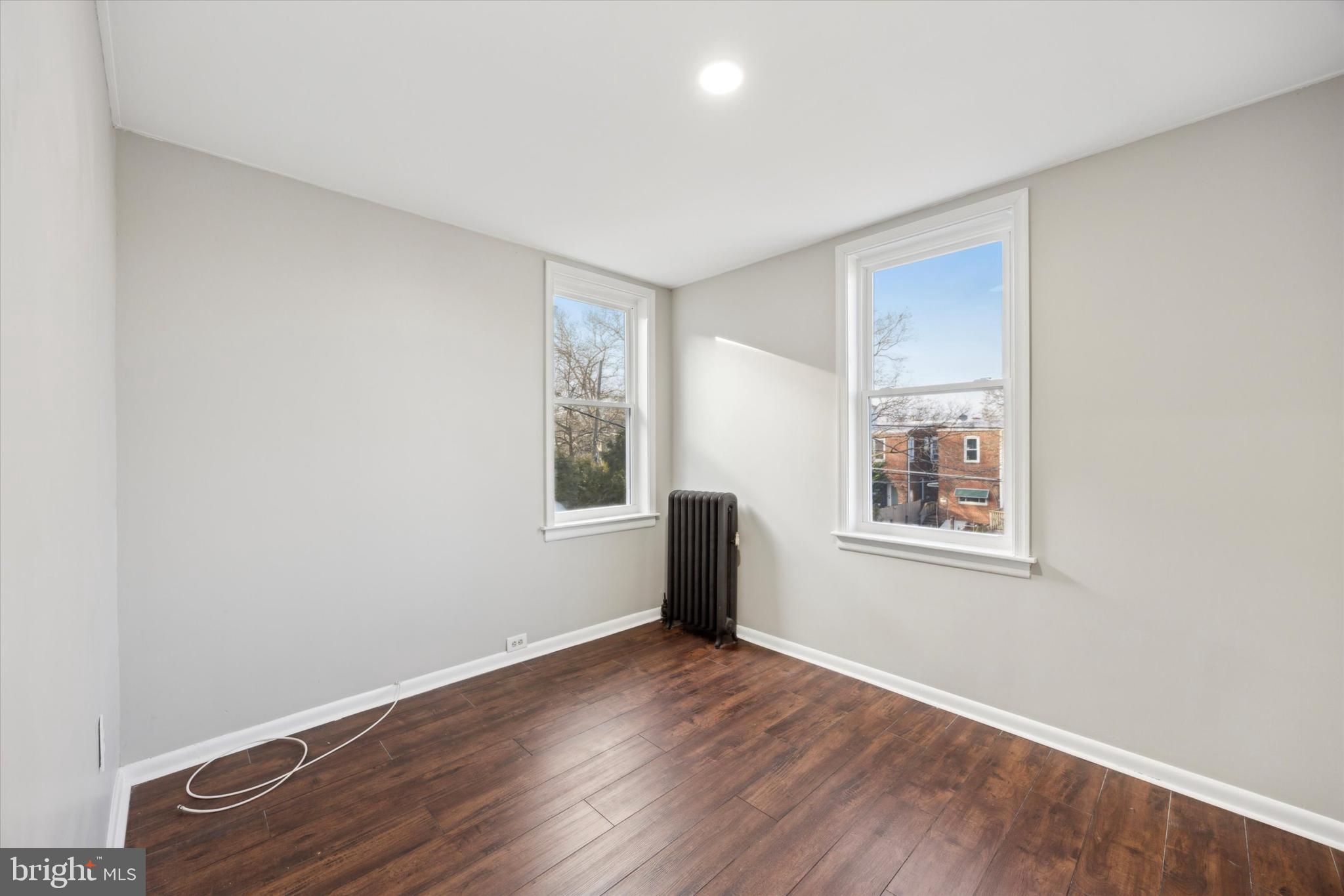 147 7th Avenue Roebling, NJ 08554 - Photo 10 of 13 an empty room with wooden floor and windows