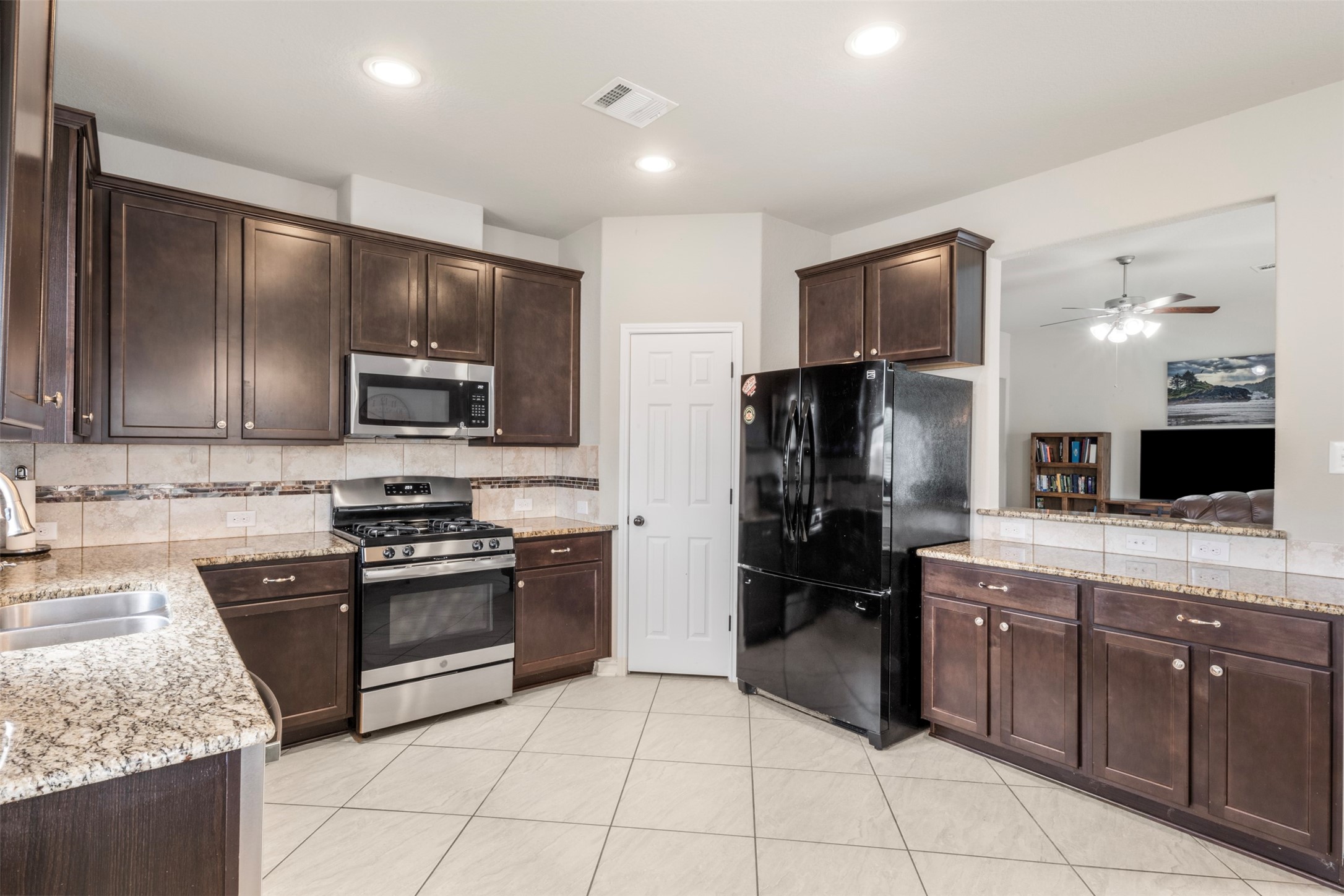 6210 Mason Way Rosenberg, TX 77471 - Photo 13 of 31 a kitchen with stainless steel appliances granite countertop a refrigerator and a stove top oven
