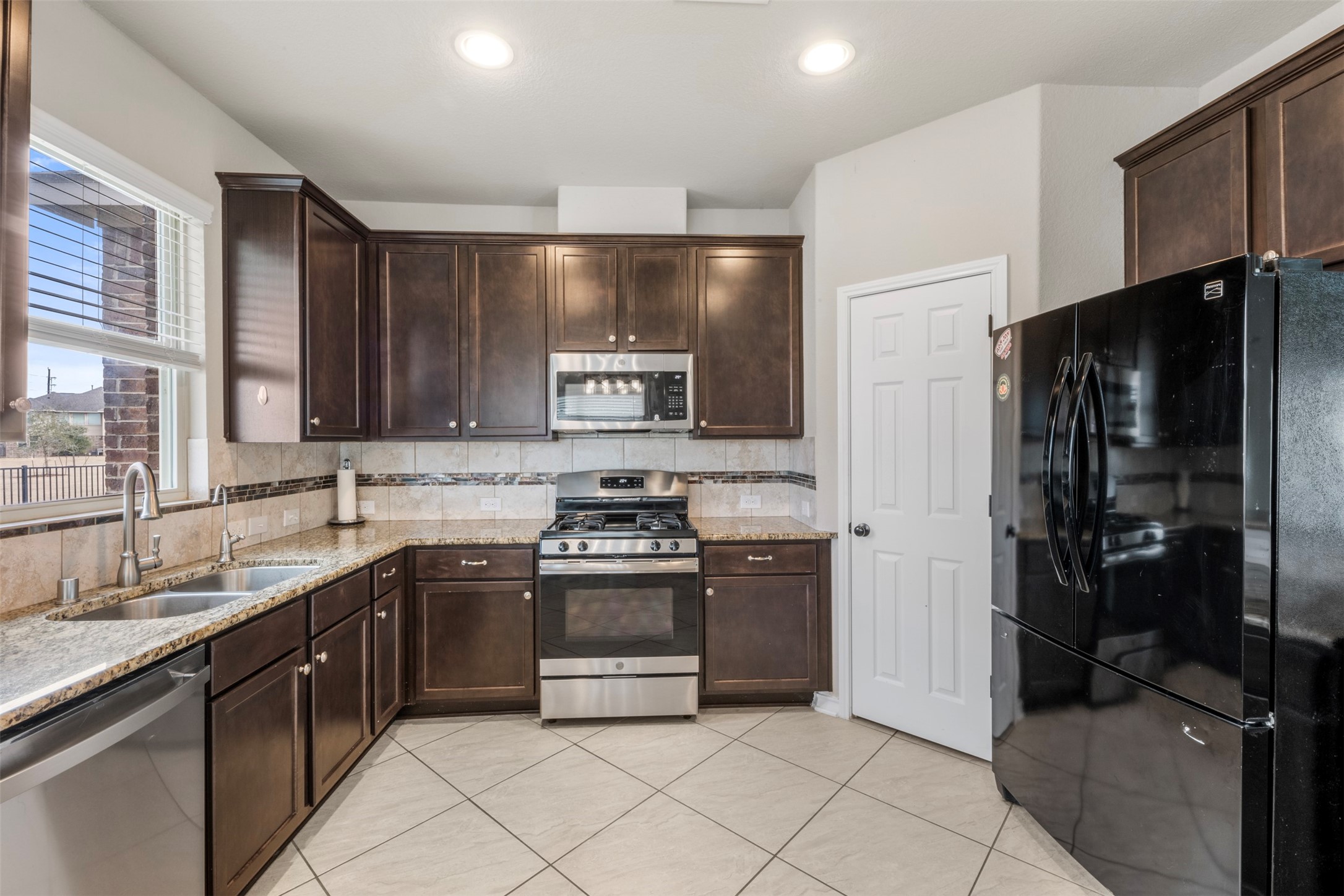 6210 Mason Way Rosenberg, TX 77471 - Photo 10 of 31 a kitchen with stainless steel appliances granite countertop a refrigerator and a sink