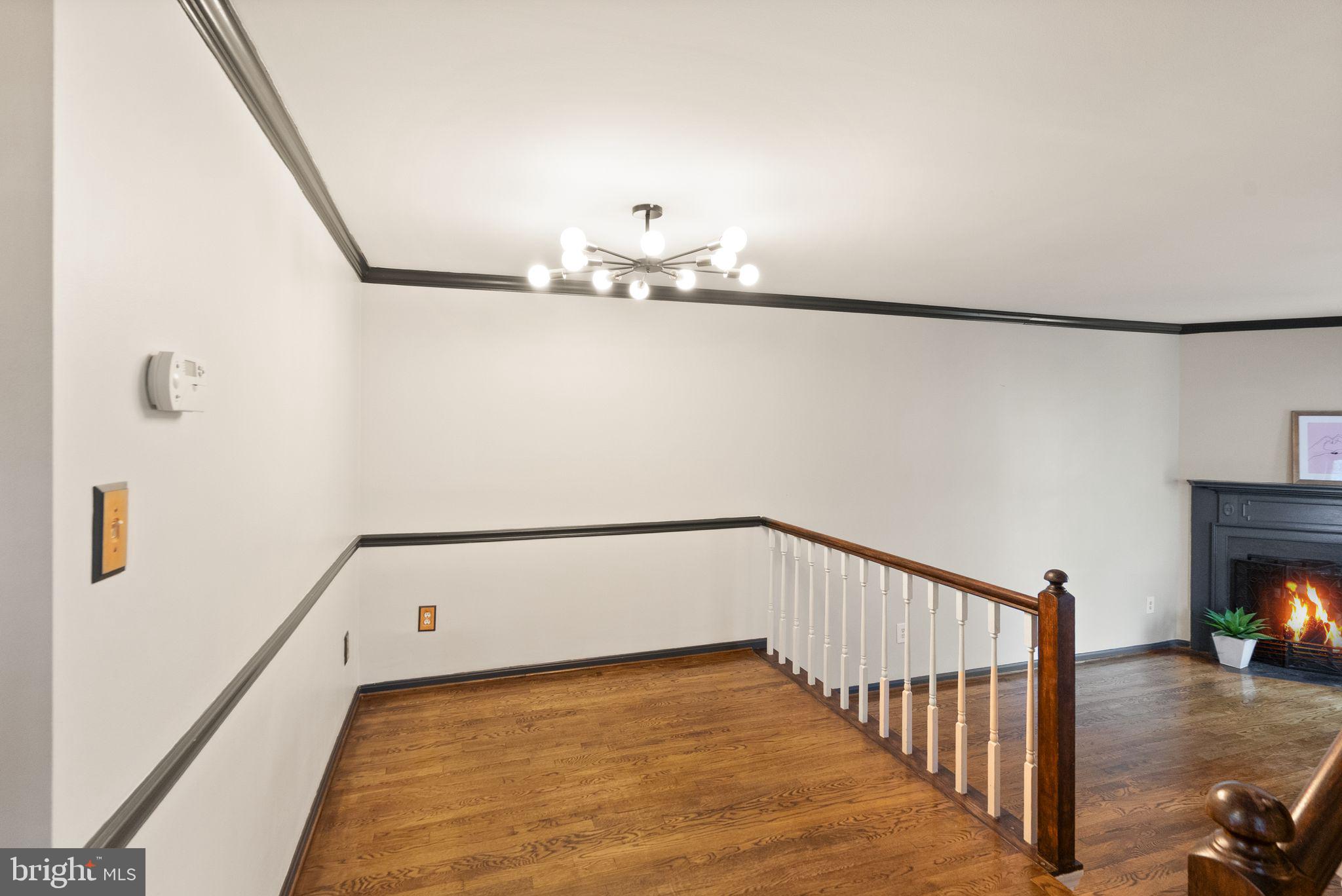 1700 Quietree Drive Reston, VA 20194 - Photo 11 of 76 a view of a livingroom with wooden floor and a refrigerator