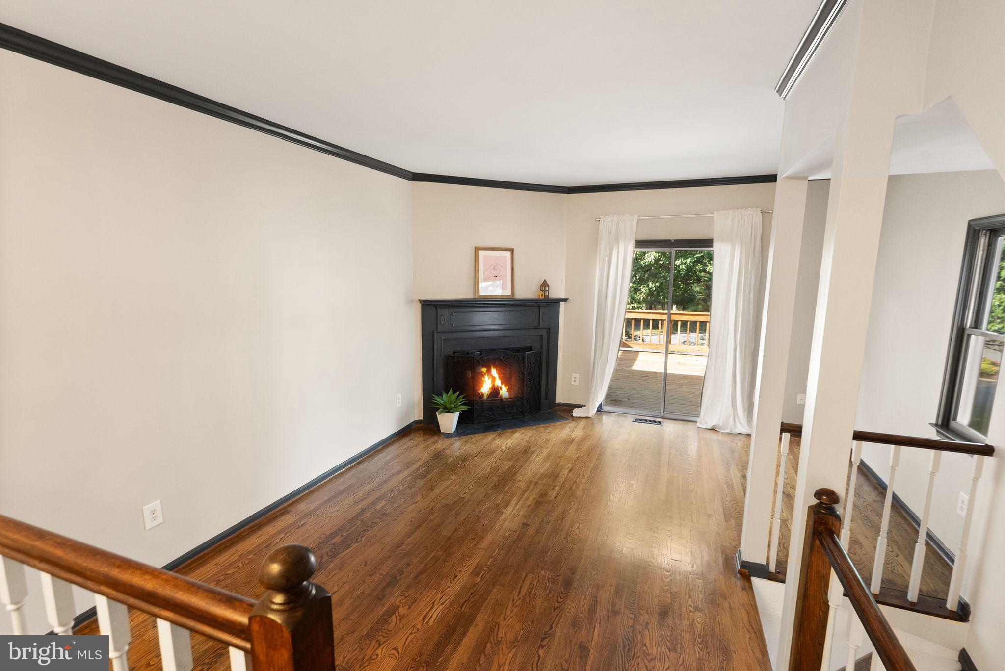 1700 Quietree Drive Reston, VA 20194 - Photo 14 of 76 a view of an empty room with wooden floor fireplace and a window