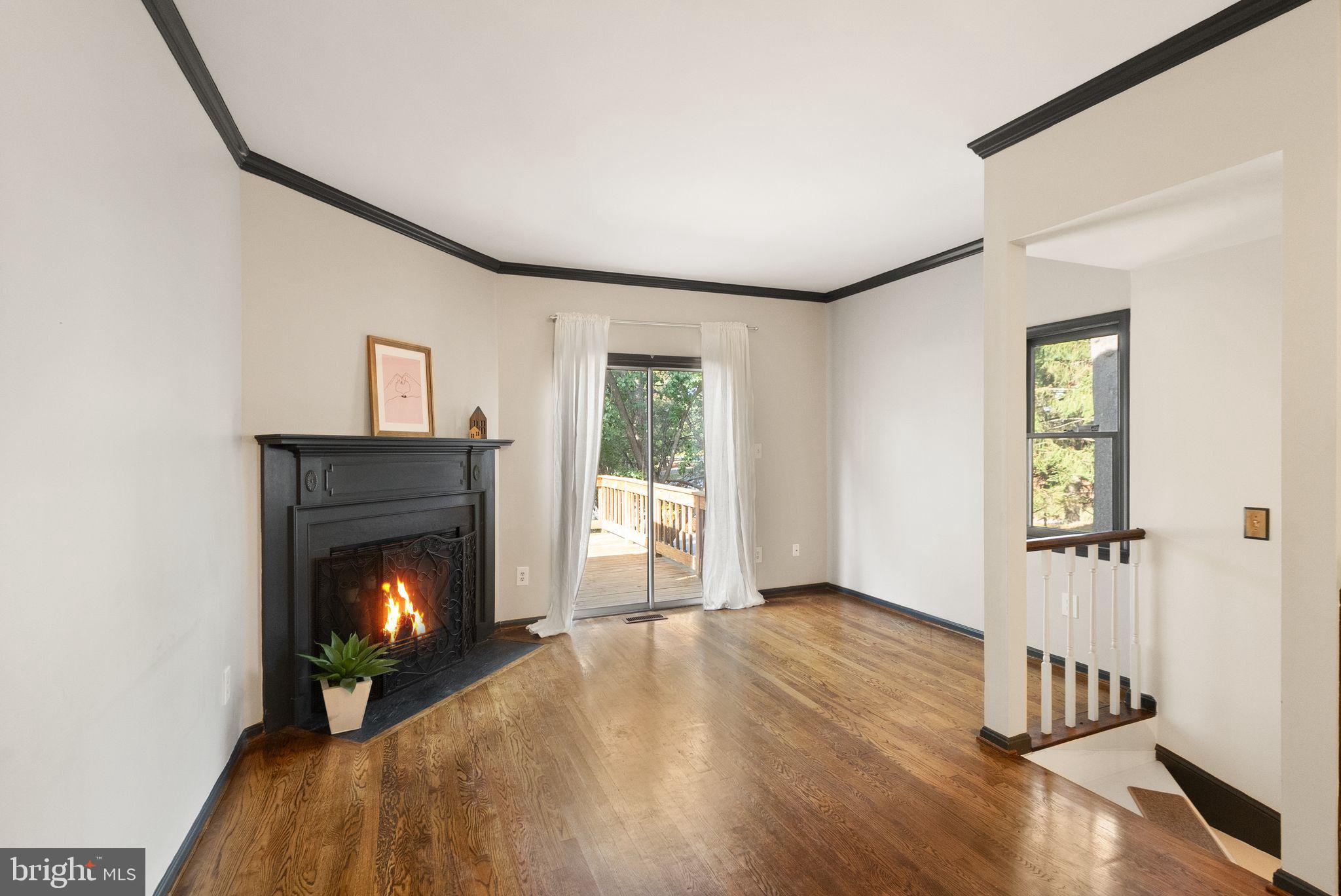 1700 Quietree Drive Reston, VA 20194 - Photo 15 of 76 a living room with wooden floor and a fireplace