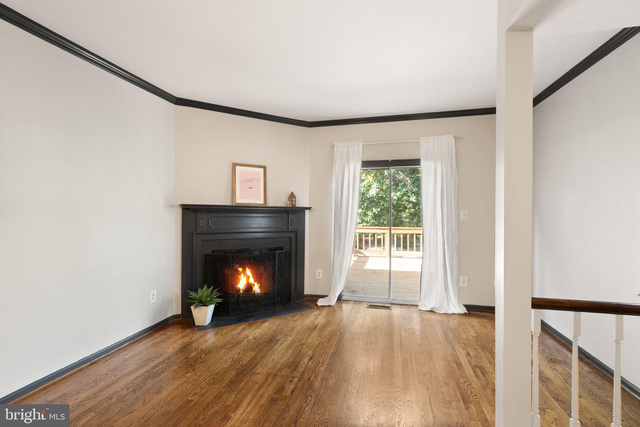 1700 Quietree Drive Reston, VA 20194 - Photo 16 of 76 a view of an empty room with wooden floor fireplace and a window