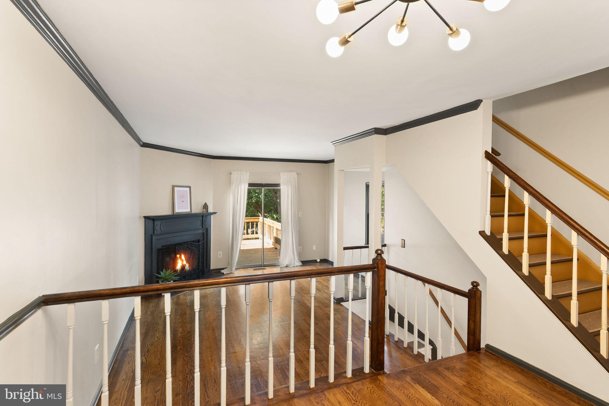 1700 Quietree Drive Reston, VA 20194 - Photo 20 of 76 a view of staircase with wooden floor and fan