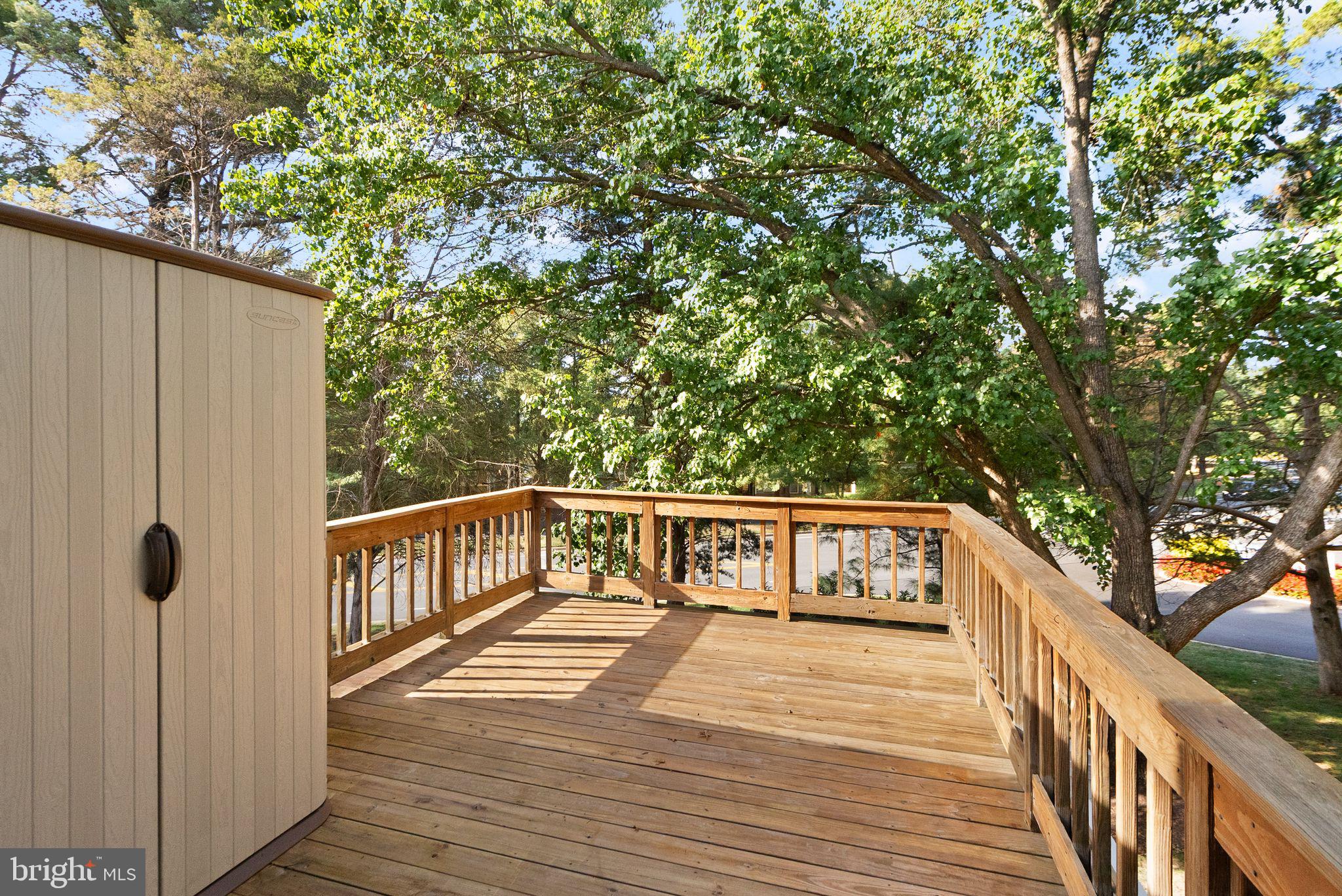 1700 Quietree Drive Reston, VA 20194 - Photo 25 of 76 a view of balcony with wooden floor and fence and a bench