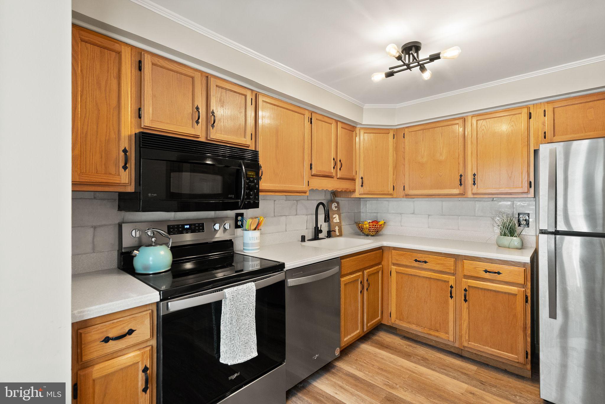 1700 Quietree Drive Reston, VA 20194 - Photo 29 of 76 a kitchen with a sink appliances cabinets and a window