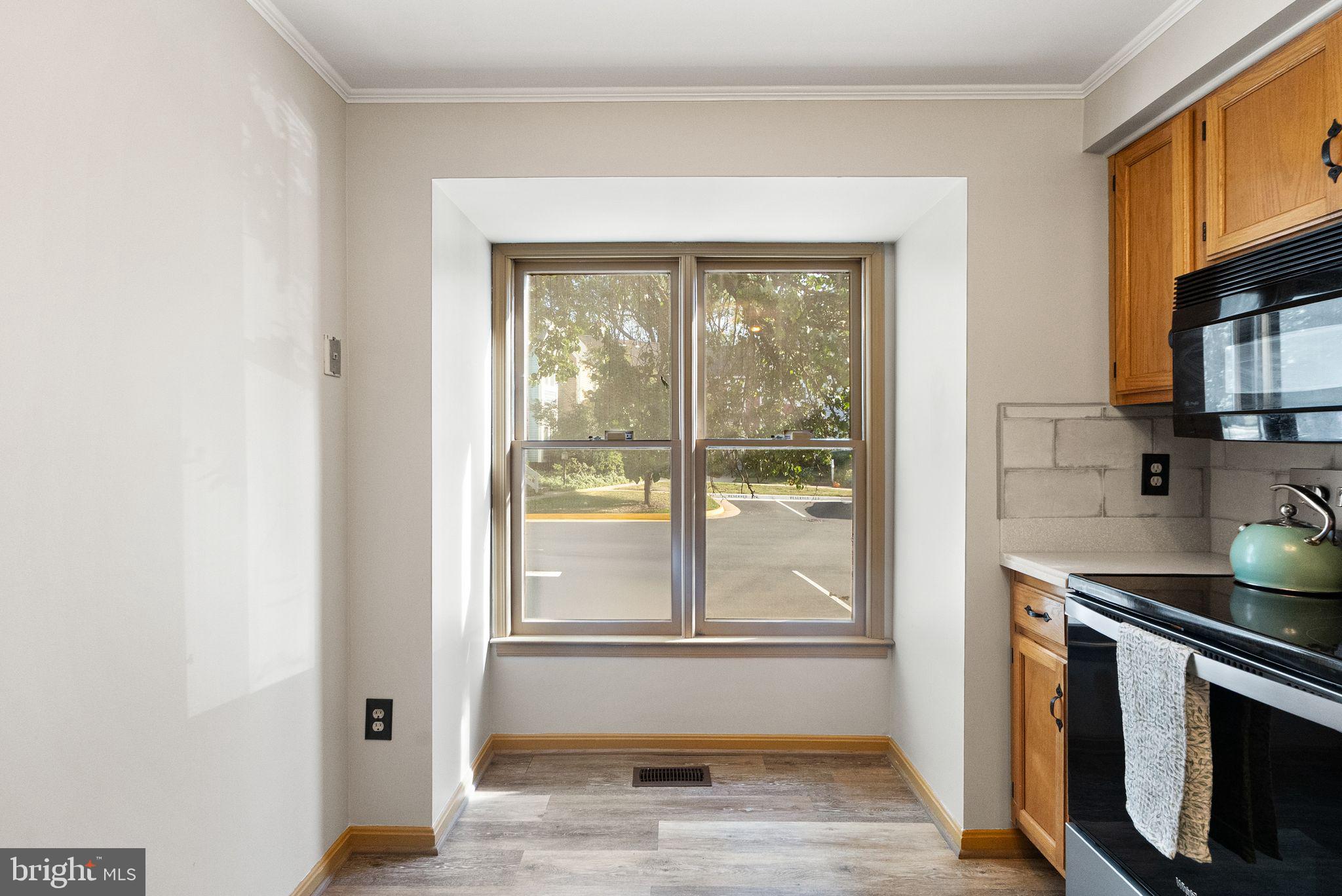 1700 Quietree Drive Reston, VA 20194 - Photo 33 of 76 a kitchen with stainless steel appliances granite countertop a stove a sink and a refrigerator with wooden floor