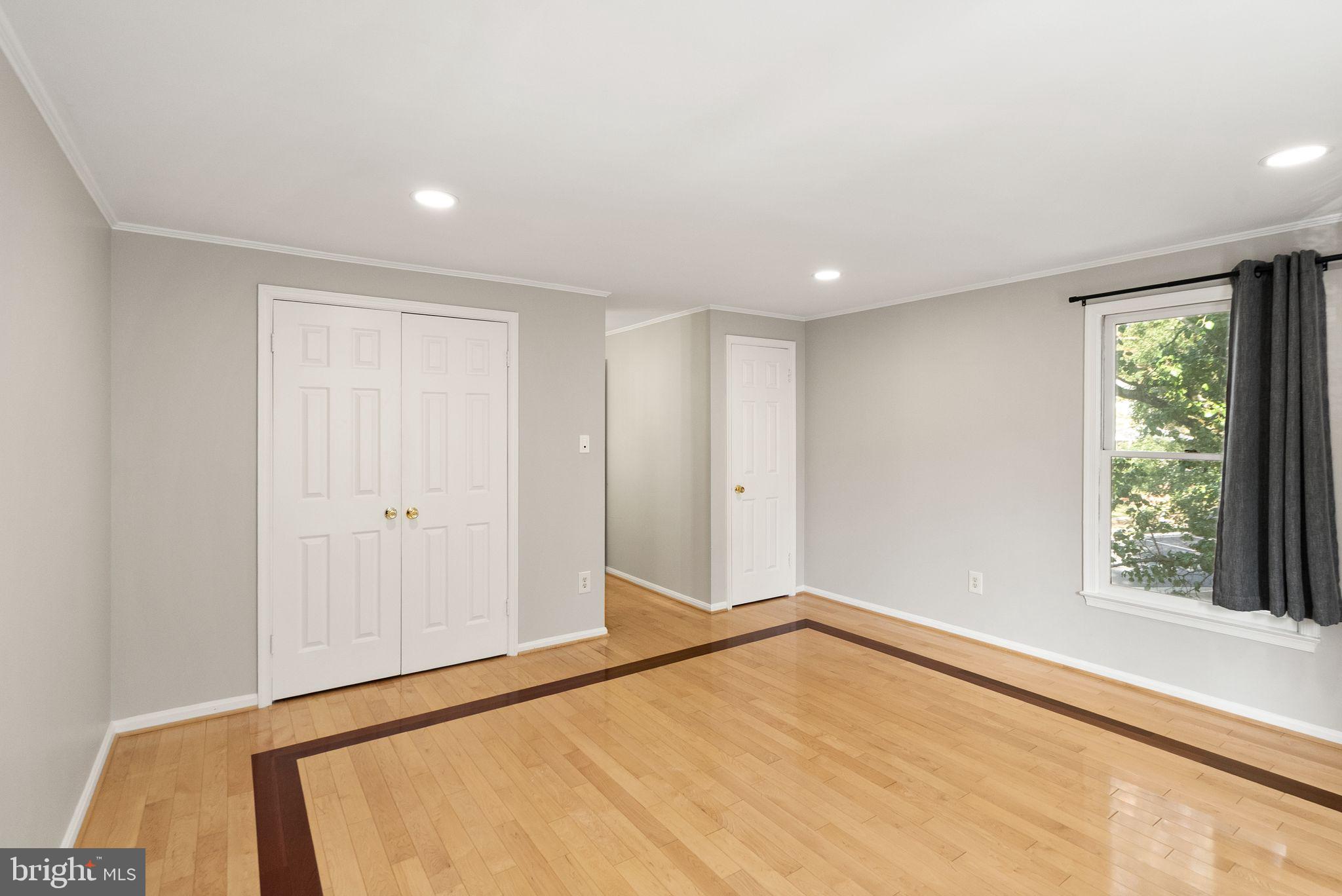 1700 Quietree Drive Reston, VA 20194 - Photo 42 of 76 a view of an empty room with wooden floor and a window