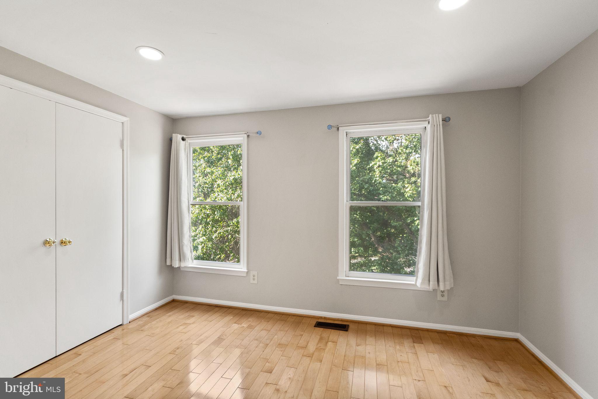 1700 Quietree Drive Reston, VA 20194 - Photo 45 of 76 a view of an empty room with wooden floor and a window