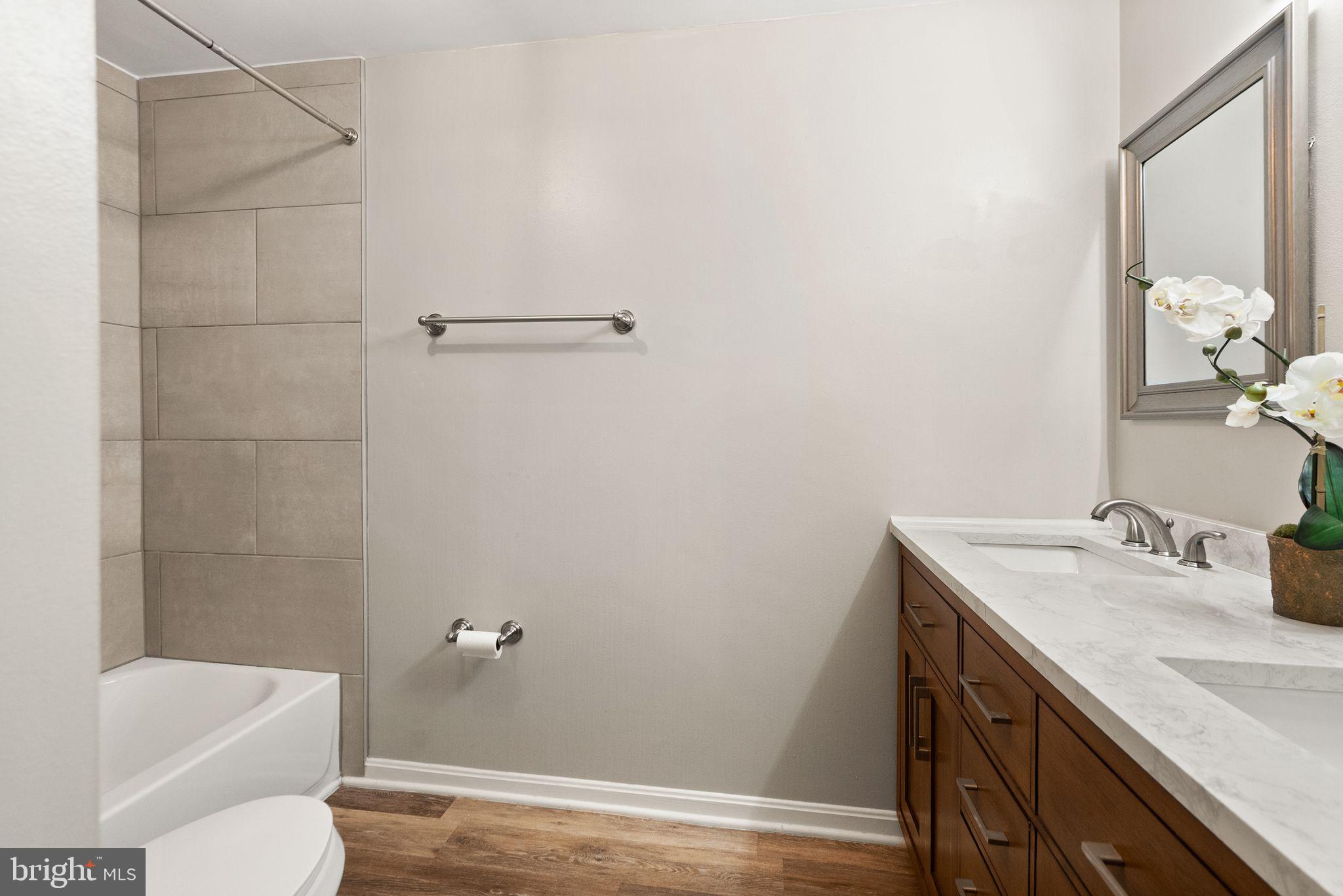 1700 Quietree Drive Reston, VA 20194 - Photo 48 of 76 a bathroom with a sink a toilet and shower