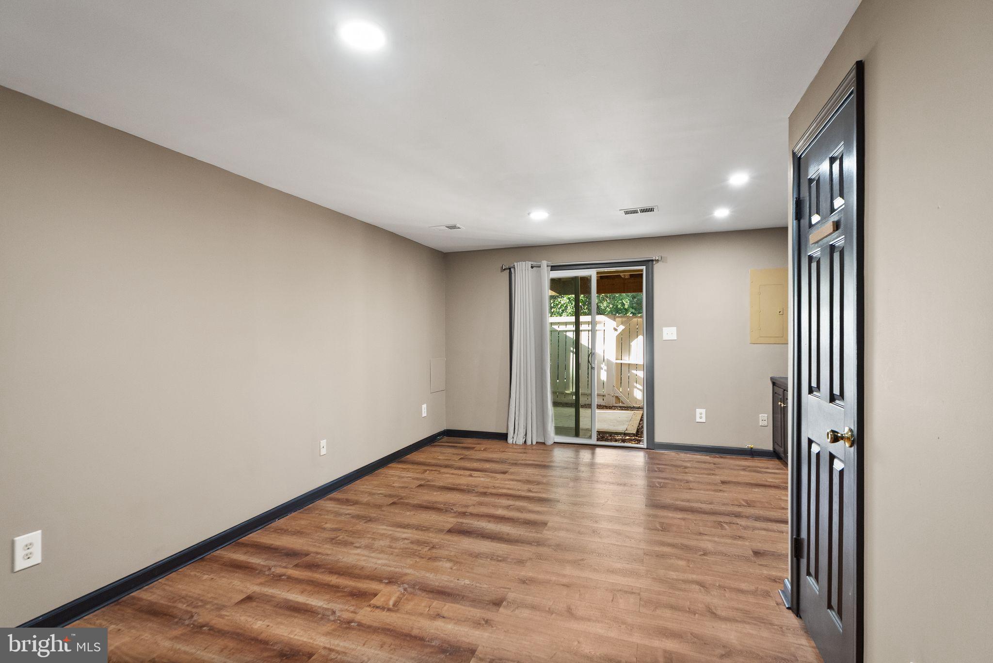 1700 Quietree Drive Reston, VA 20194 - Photo 56 of 76 a view of an empty room with wooden floor and a window