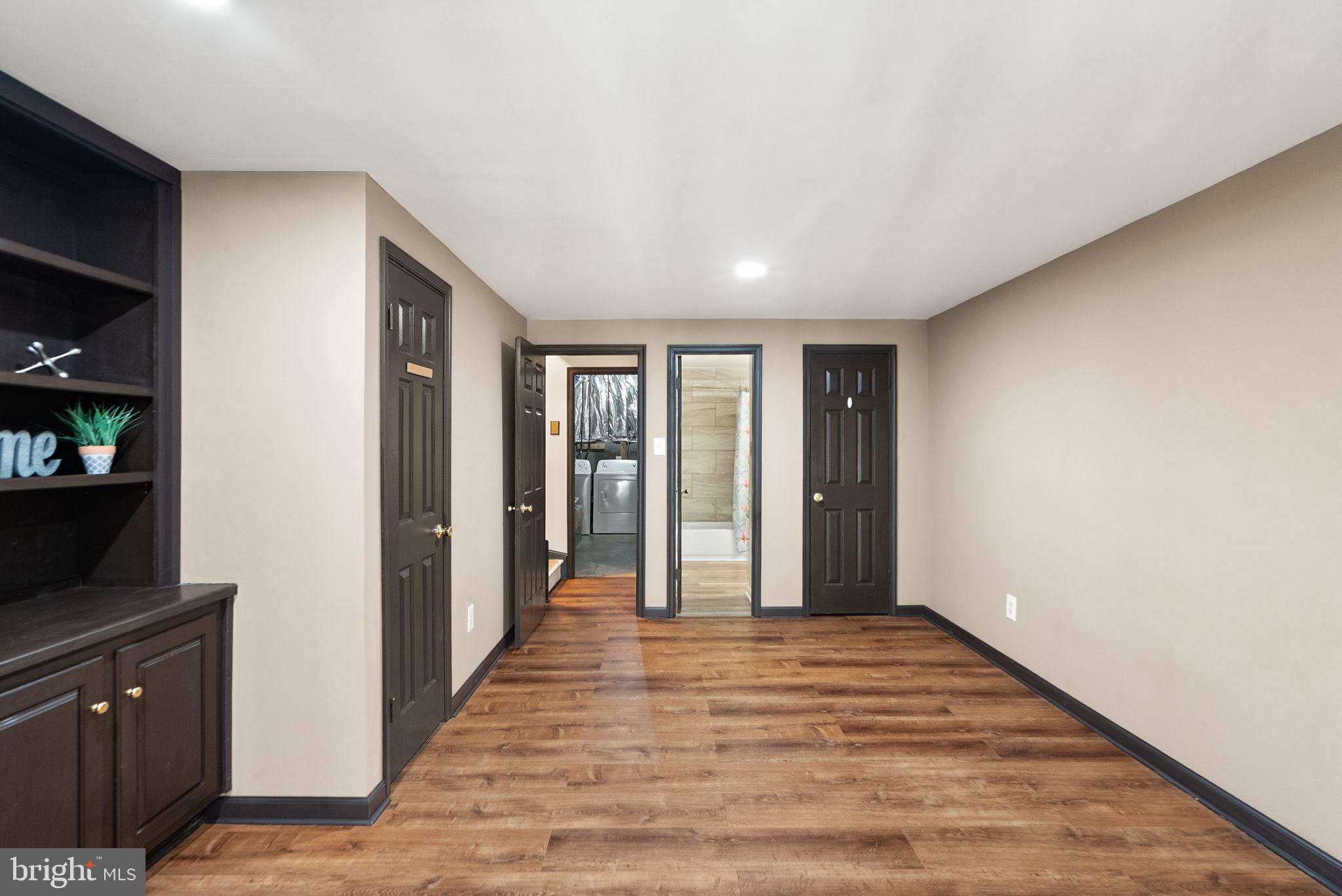 1700 Quietree Drive Reston, VA 20194 - Photo 58 of 76 a view of a hallway with wooden floor and cabinet