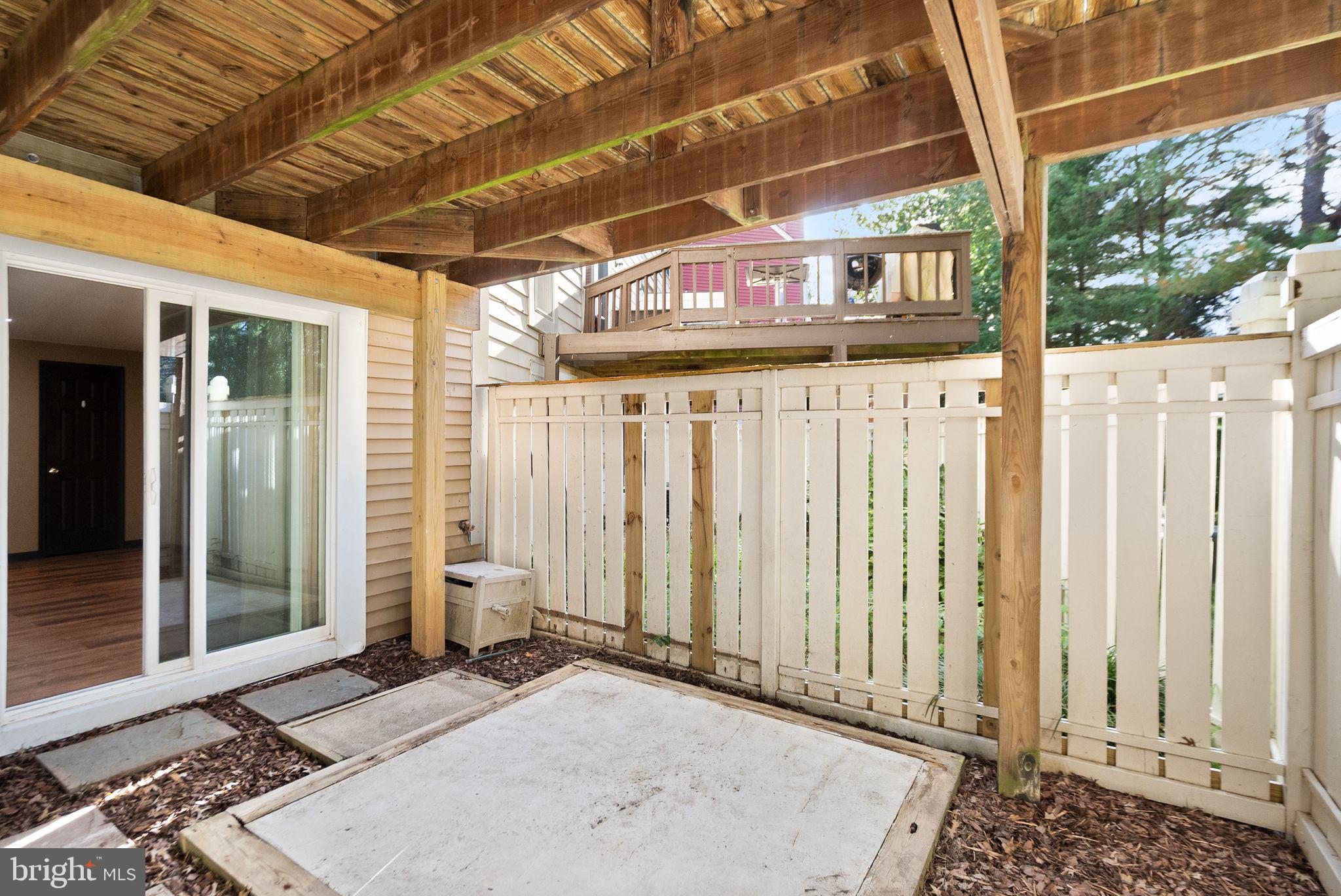 1700 Quietree Drive Reston, VA 20194 - Photo 66 of 76 a front view of a house with a wooden fence