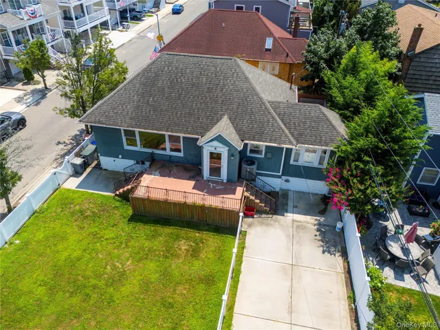 a aerial view of a house with swimming pool and a yard