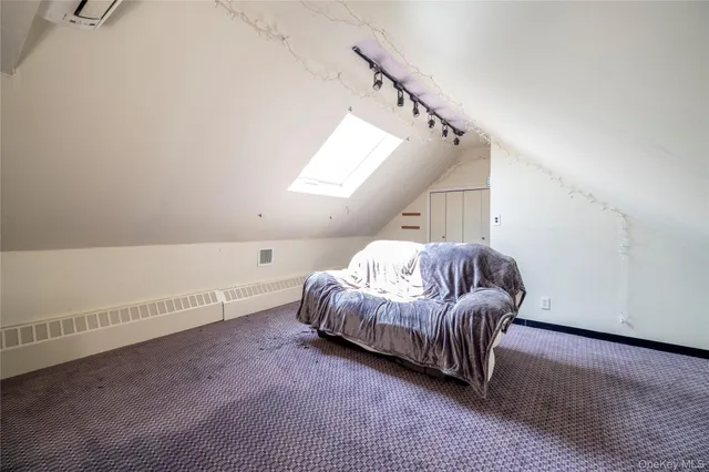 a spacious bedroom with a bed and a window