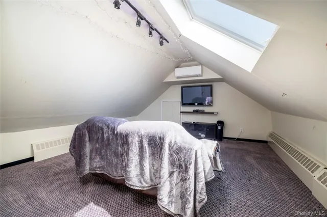 a bedroom with a bed and a fireplace