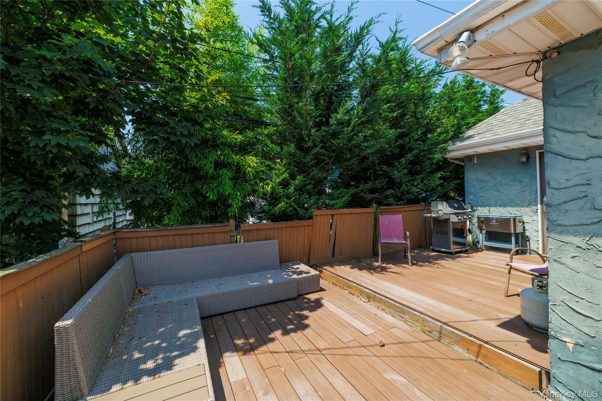 49 Barnes Street Long Beach, NY 11561 - Photo 22 of 30 a view of roof deck with couches and wooden fence