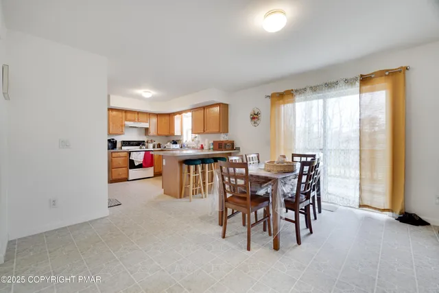 a view of a dining room with furniture and a window