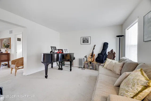 a living room with furniture a rug and a large window