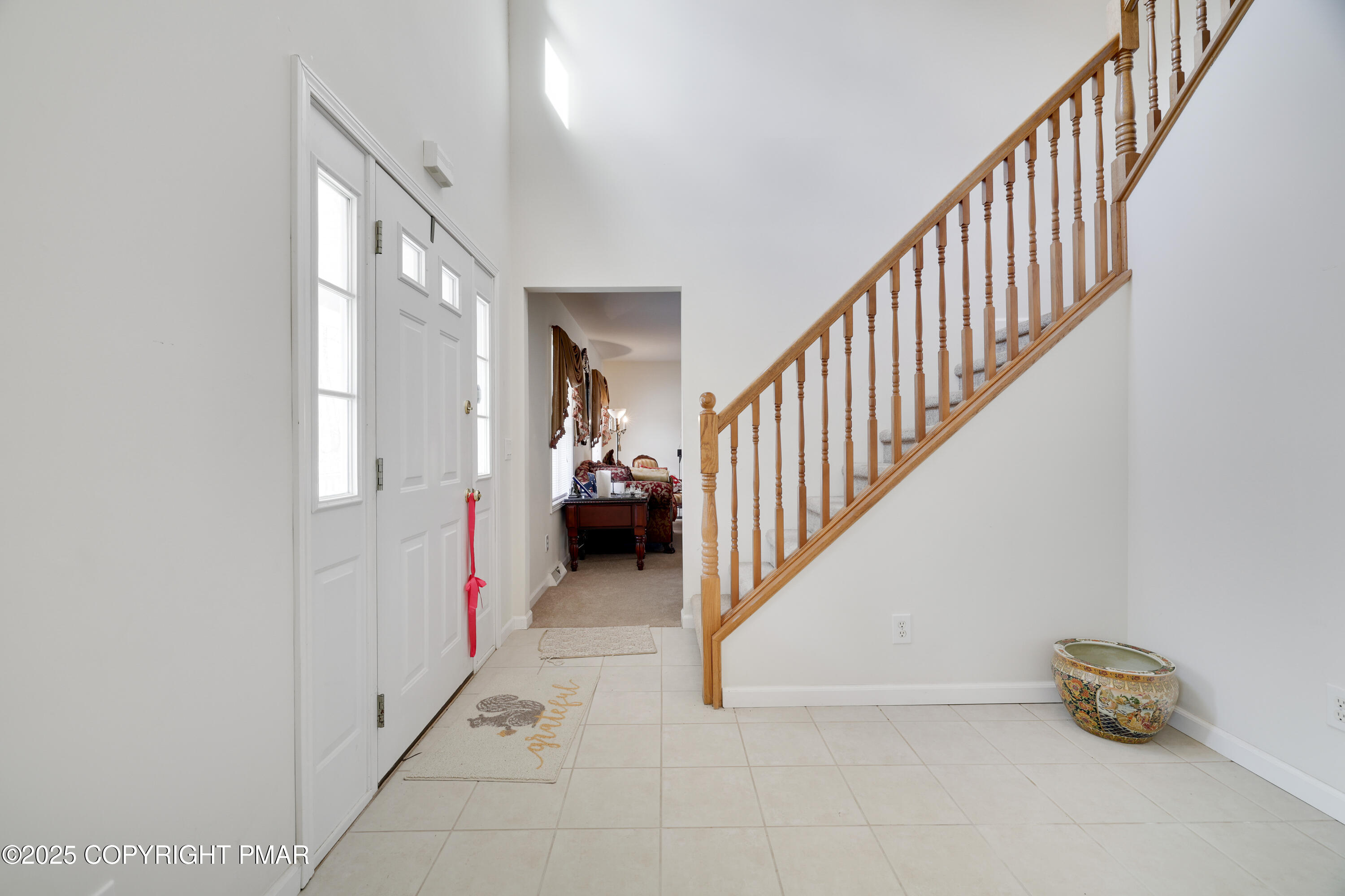 138 Jennifer Lane Effort, PA 18330 - Photo 20 of 41 a view of a hallway to a livingroom with wooden floor and stairs