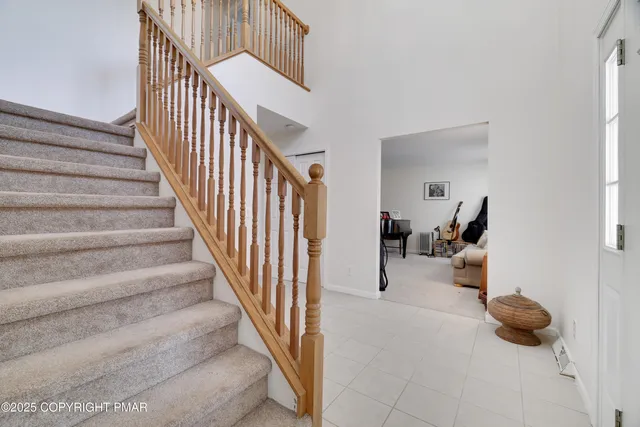 a view of staircase and living room with wooden floor