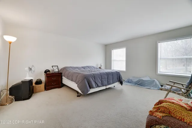 a bedroom with a bed and window