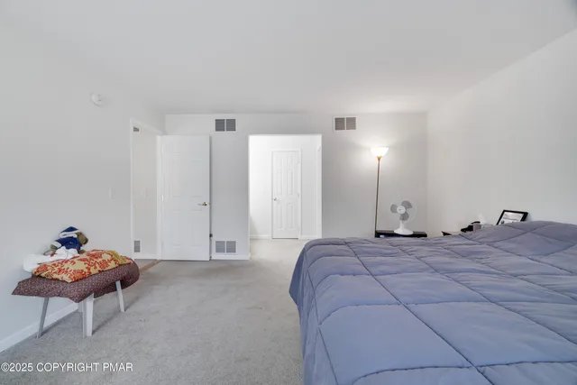 a bed room with a bed and a chair