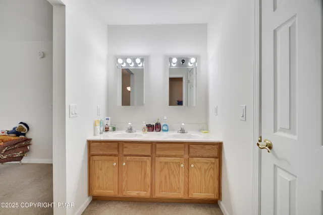 a bathroom with a double vanity sink and mirror