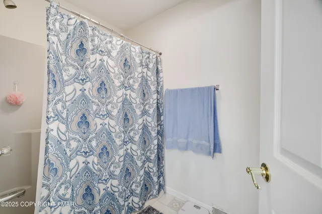 a bathroom with a shower curtain and a shower curtain