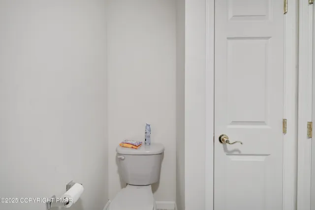 a white toilet sitting next to a bathroom sink