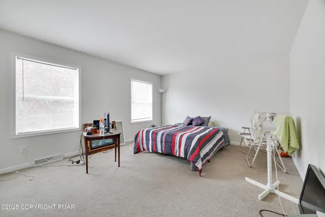 a bedroom with a bed chair and window