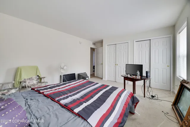 a bedroom with a bed and a chair in it